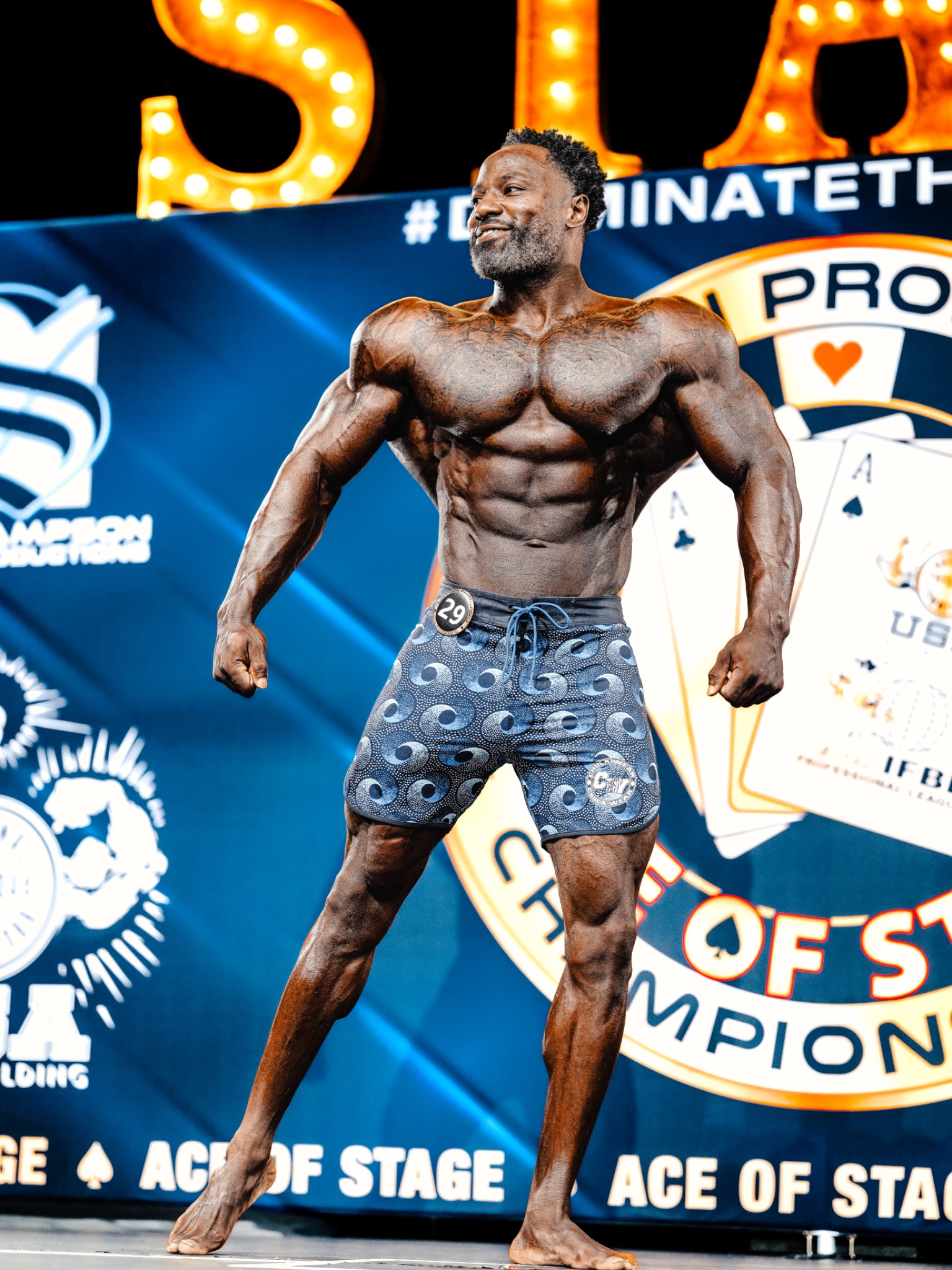 Dr. Jonathean Reese competing on a Men’s Physique stage